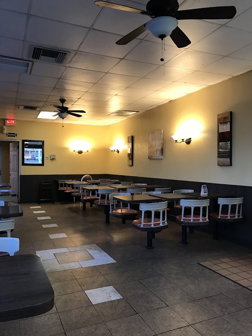 Bright dining room with wall decor and booths.