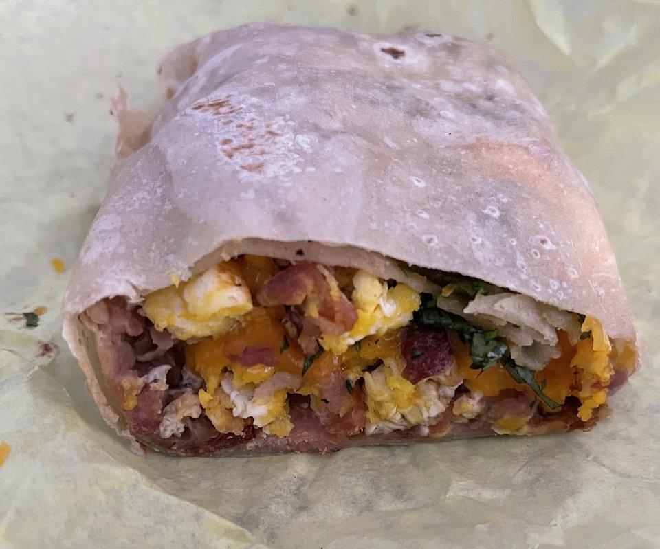Printed menu with breakfast burritos and tacos.